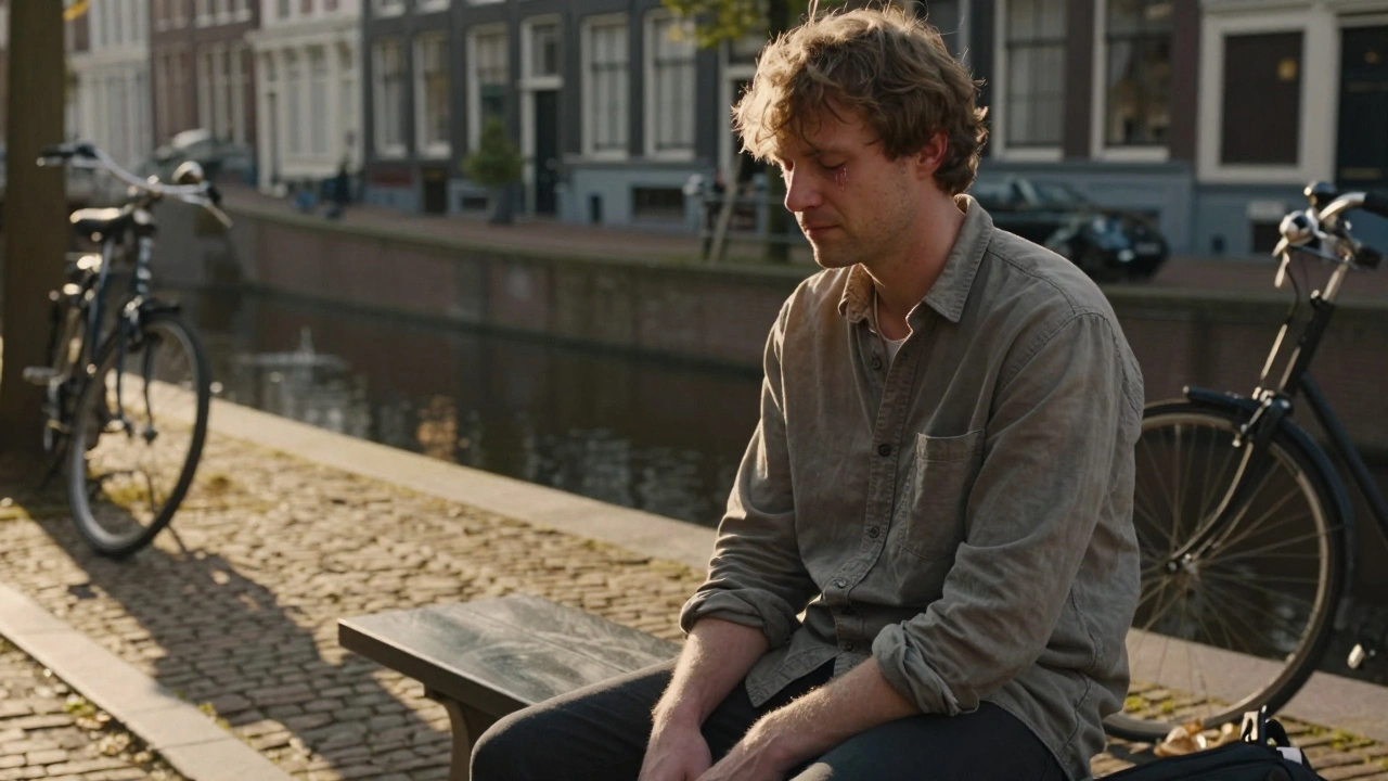 A man sitting quietly outside a massage studio in Amsterdam, tear-stained but serene, after an emotional release.